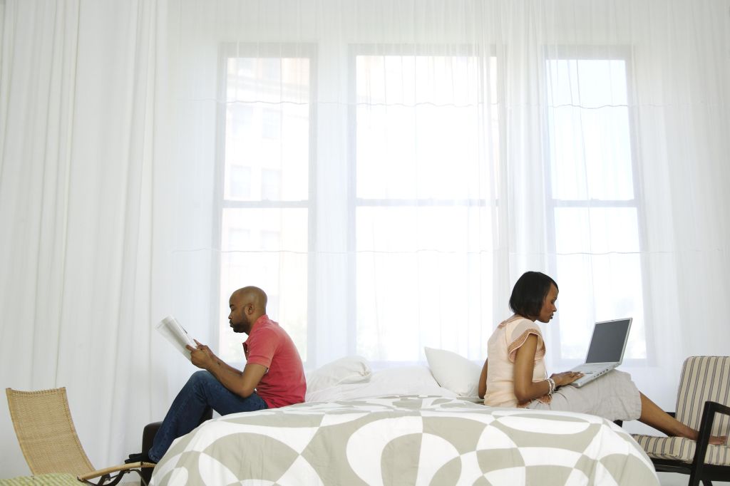 African American couple on bed together