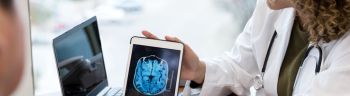 Neurologist reviews patient's brain MRI scan