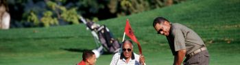Grandfather Teaching Golf to Grandson