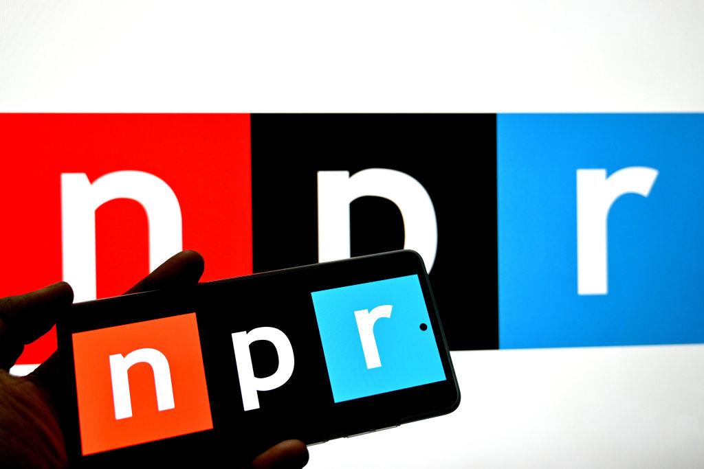 In this photo illustration, a NPR logo is seen displayed on...